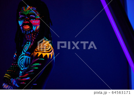 colorful ethnic fluorescent prints on man's body 64563171