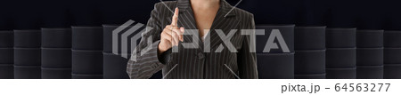 Businesswoman hand on crude oil barrels background Businesswoman hand on crude oil barrels background 64563277