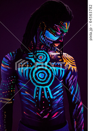 colorful ethnic fluorescent prints on man's body 64563782
