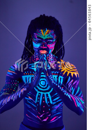 young man blur with ultraviolet body art 64563843