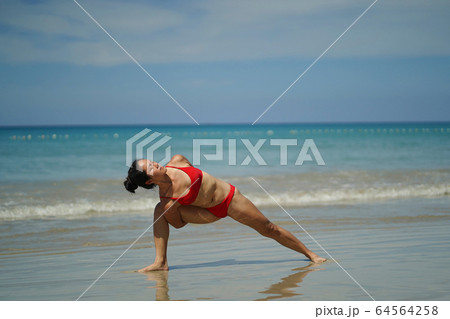 Asian Chinese Woman in various yoga poses at the 64564258