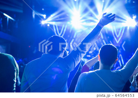The audience watching the concert on stage. The audience watching the concert on stage. 64564553