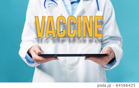 Vaccine theme with a doctor using a tablet pc 64566425