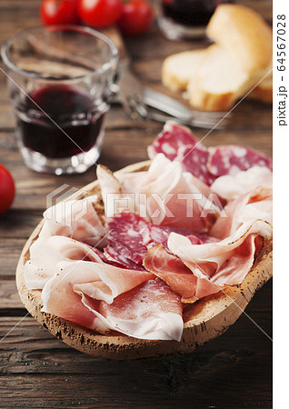 Plate with ham, bacon, salami and bread Plate with ham, bacon, salami and bread 64567028