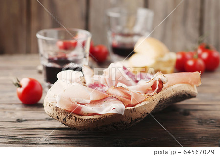 Plate with ham, bacon, salami and bread Plate with ham, bacon, salami and bread 64567029