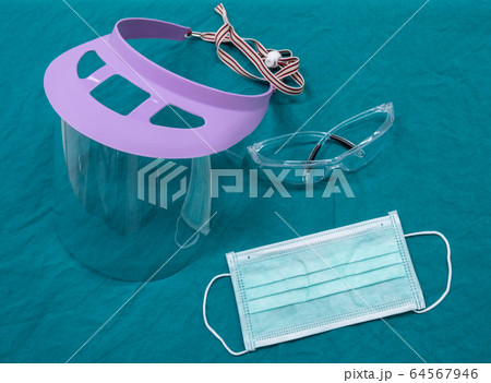 Group of protective headwear for Doctor and Nurse (such as surgical mask, face shield and safety glasses) before surgery in operating room. Conceptual of important objects in covid-19 outbreak. 64567946