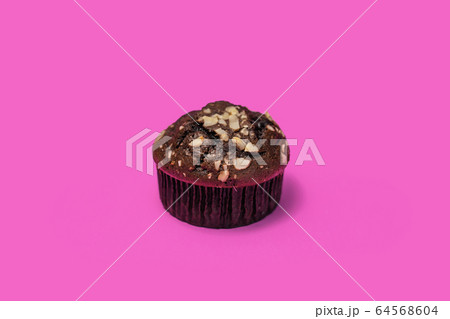 Chocolate chip muffins on a pink background Chocolate chip muffins on a pink background 64568604