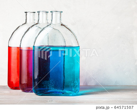 three flasks with color ink solutions on gray three flasks with color ink solutions on gray 64571507