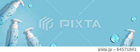 Hand sanitizer bottle on on blue background for COVID-19. Hygiene Coronavirus concept. Pattern. Banner 64571941