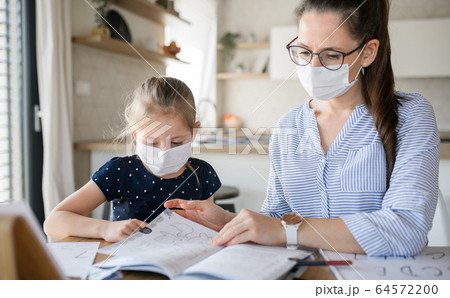 Mother and daughter learning indoors at home, Corona virus and quarantine concept. Mother and daughter learning indoors at home, Corona virus and quarantine concept. 64572200