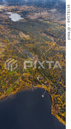 Drone view point of rural area in Autumn with lake Boroye, The big wooden house in forest, Piers on the lake, Valday national park, Russia, panoramic image, golden trees, Wooden lodges, cloudy weather Drone view point of rural area in Autumn with lake Boroye, The big wooden house in forest, Piers on the lake, Valday national park, Russia, panoramic image, golden trees, Wooden lodges, cloudy weather 64578136
