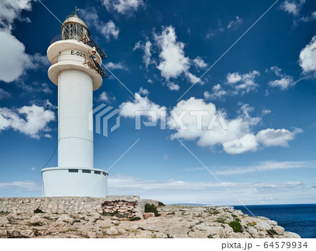 Lighthouse on the Formentera island, Spain, the blue sky with white clouds, without people, rocks, stones, sunny weather 64579934