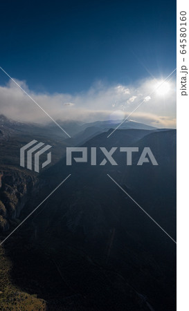 Aerial view of mountains at sunrise, Morning fog over mountains, Sun beams Aerial view of mountains at sunrise, Morning fog over mountains, Sun beams 64580160