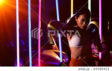 Woman trains exercise Boxing boxer neon modern gym 64580423