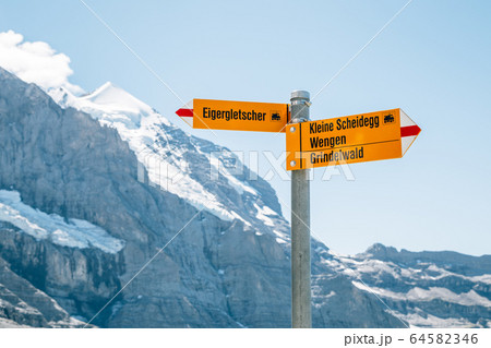 Jungfrau region arrow direction sign with snowy mountain in Switzerland 64582346