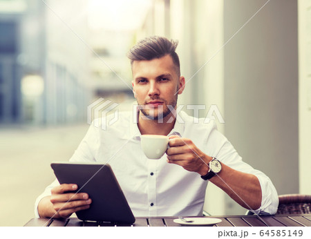 man with tablet pc and coffee at city cafe man with tablet pc and coffee at city cafe 64585149
