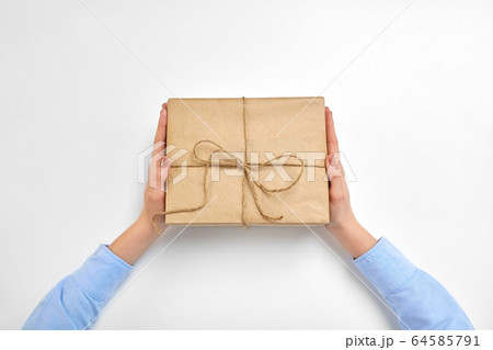 hands with parcel box tied by rope at post office hands with parcel box tied by rope at post office 64585791