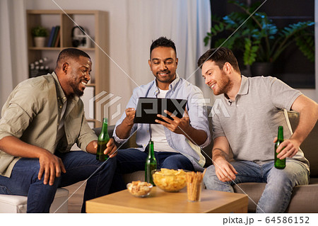 male friends with tablet pc drinking beer at home male friends with tablet pc drinking beer at home 64586152