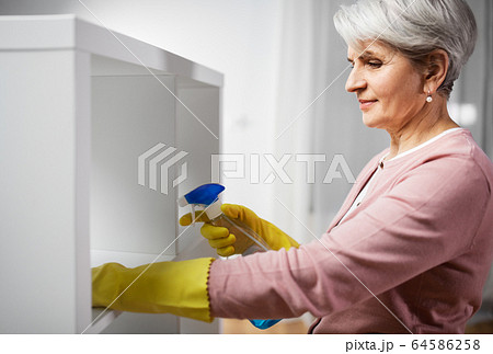 senior woman cleaning rack with detergent at home senior woman cleaning rack with detergent at home 64586258