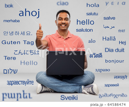 happy indian man with laptop showing thumbs up 64586474