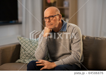 sad senior man in glasses thinking at home 64586876