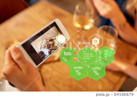hands with food on smartphone screen at restaurant hands with food on smartphone screen at restaurant 64586879