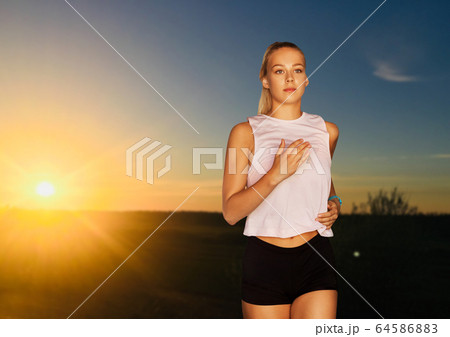 happy young woman running outdoors 64586883