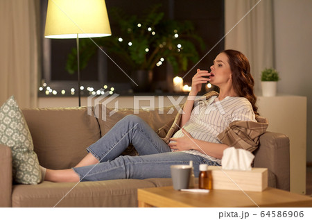 sick pregnant woman coughing at home 64586906