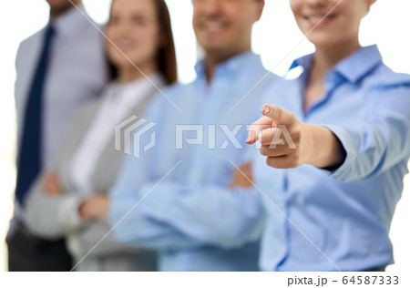 close up of smiling businesswoman pointing finger 64587333