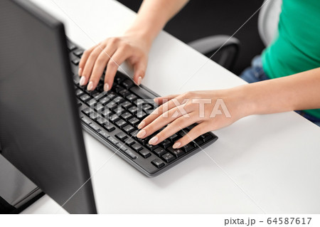 female hands typing on computer keyboard female hands typing on computer keyboard 64587617
