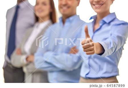 close up of happy businesswoman showing thumbs up close up of happy businesswoman showing thumbs up 64587899