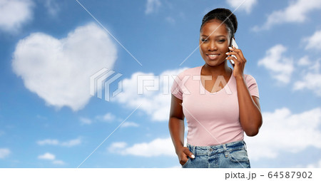 happy african american woman calling on smartphone happy african american woman calling on smartphone 64587902