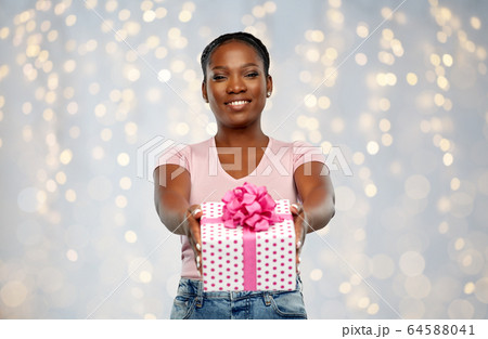 happy african american woman with birthday present happy african american woman with birthday present 64588041