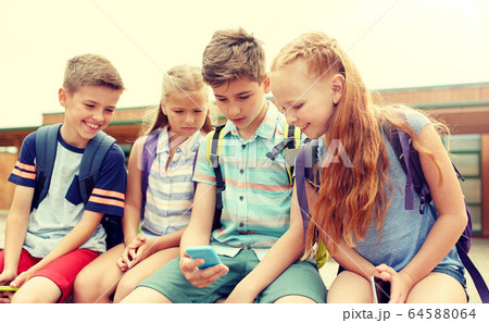 elementary school students with smartphones 64588064