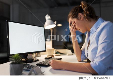 sad businesswoman with computer at night office sad businesswoman with computer at night office 64588261