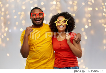 happy african american couple with party props happy african american couple with party props 64588263