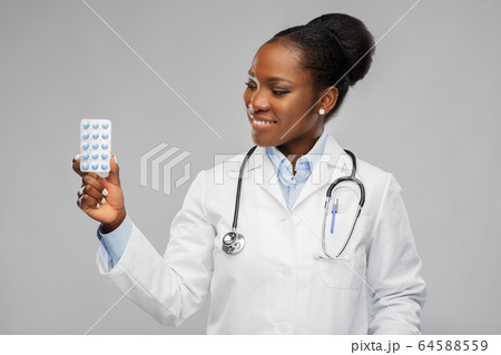 african american female doctor with medicine pills african american female doctor with medicine pills 64588559