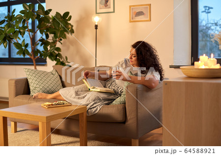woman reading book and drinking red wine at home woman reading book and drinking red wine at home 64588921