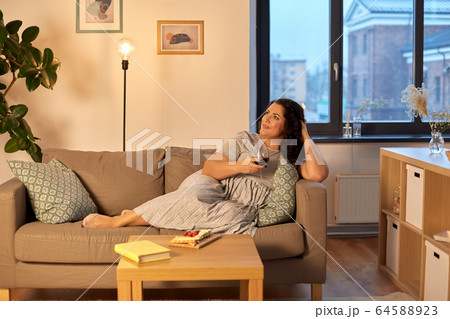 happy woman drinking red wine at home in evening 64588923