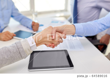 close up of businesspeople making handshake 64589016