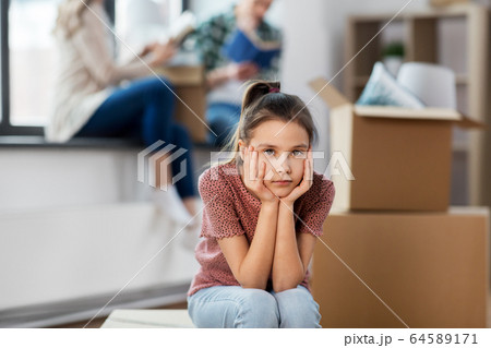 sad girl moving to new home with her family 64589171