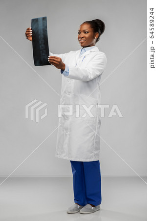 african american female doctor looking at x-ray african american female doctor looking at x-ray 64589244