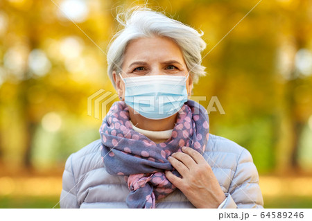senior woman in protective medical mask at park senior woman in protective medical mask at park 64589246