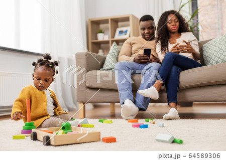 african baby girl playing with toy blocks at home african baby girl playing with toy blocks at home 64589306