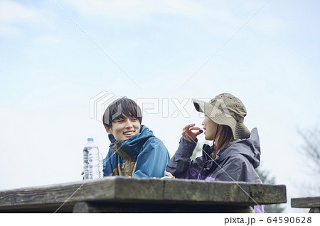 山で休憩をするカップルの写真素材