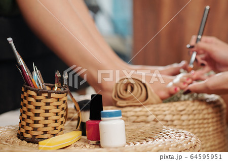 Wicker holder with pedicure tools 64595951