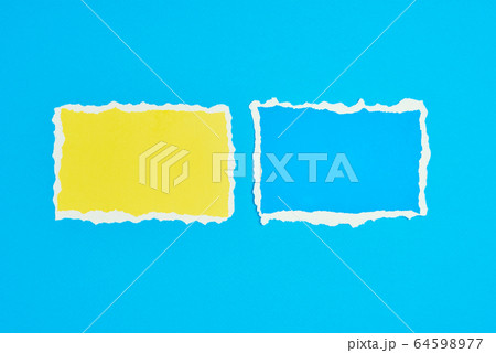 Two ripped paper torn edge sheets on a blue 64598977