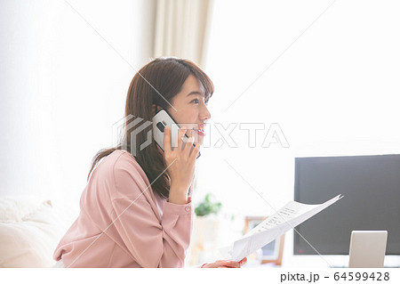 書類を確認する女性 64599428