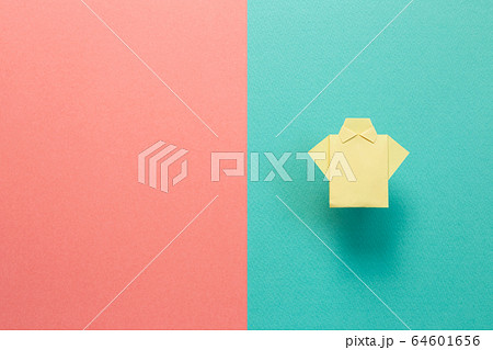 Yellow paper shirt origami on green pink background Yellow paper shirt origami on green pink background 64601656