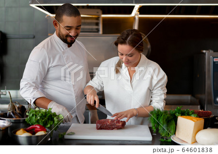 Handsome young African chef is cooking together Handsome young African chef is cooking together 64601838